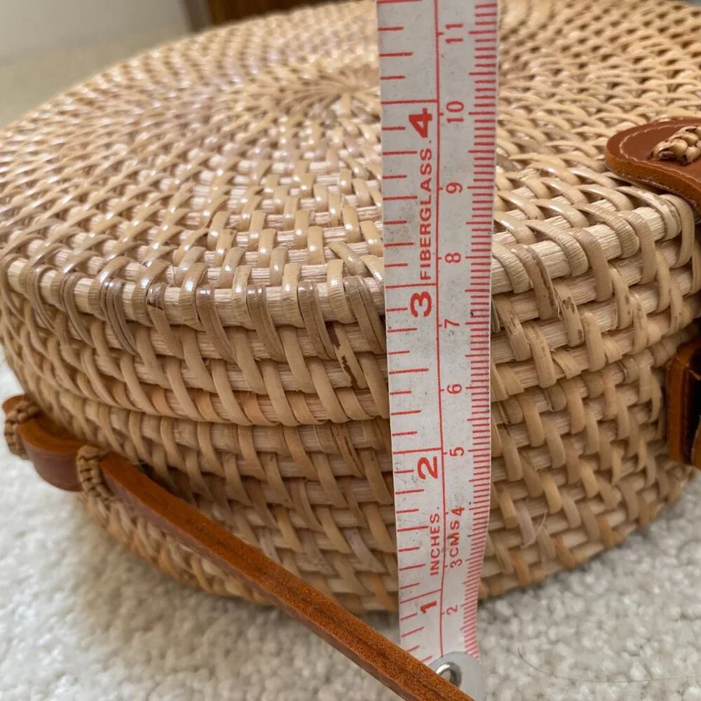 Round solid rattan woven crossbody purse cloth lined, leather accents.